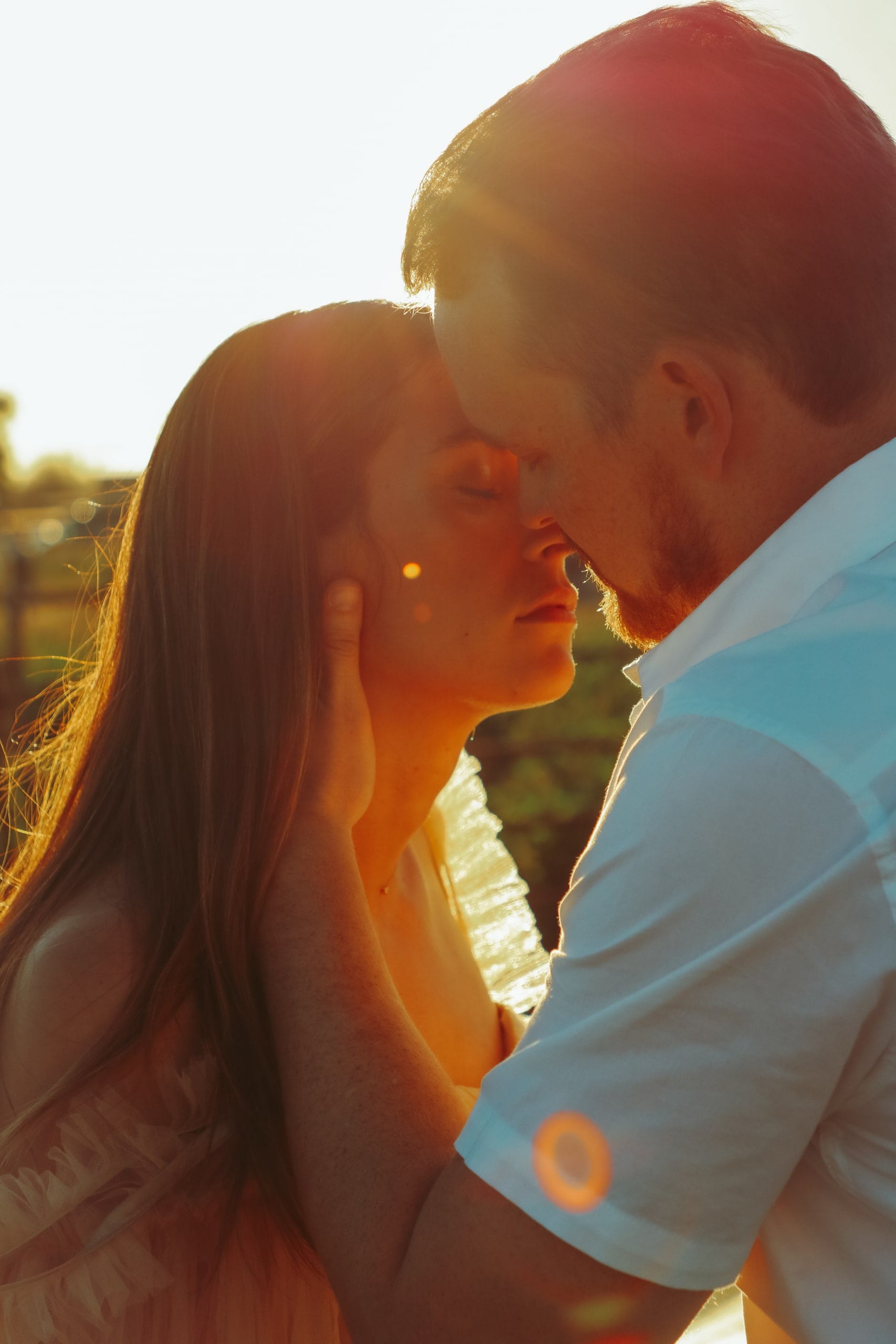 Couple nose to nose in glowing sunset light